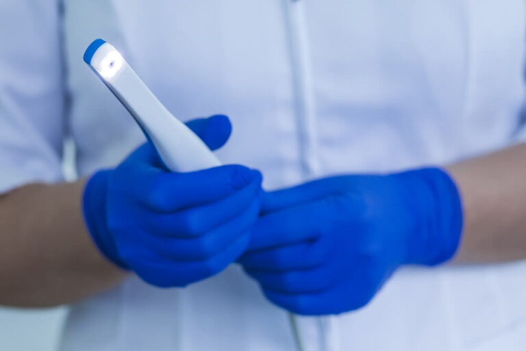 Doctor holding intraoral camera.